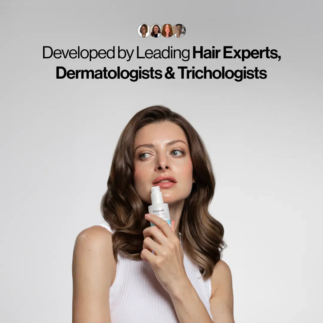 Woman holding a hair care product, developed by experts, against a neutral background.
